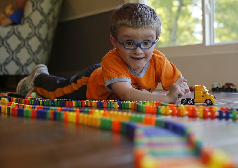 Grayson Ledbetter plays with a toy truck at his home on Tuesday, May 1, 2018 in Ooltewah, Tenn. Grayson has a rare nervous system disorder called Alexander Disease. The family has set up the group Grayson's Ladder to raise support and awareness for the disease.