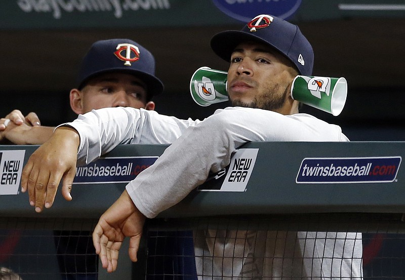 Minnesota Twins pitcher Fernando Romero watches from the dugout with drink cups attached to his ears during the team's baseball game against the Detroit Tigers on Tuesday, May 22, 2018, in Minneapolis. The Twins won 6-0. (AP Photo/Jim Mone)

