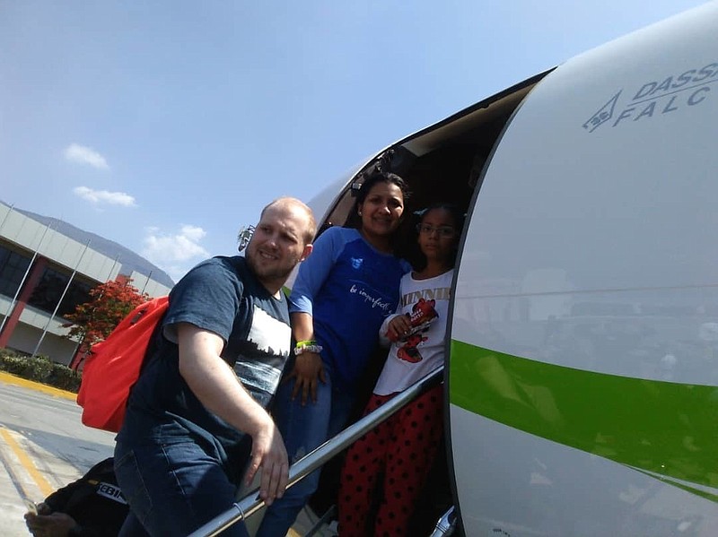 In this image provided by the Holt family, Joshua Holt, his wife Thamara and her daughter Marian Leal, board a plane at the airport in Caracas, Venezuela, Saturday, May 26, 2018.