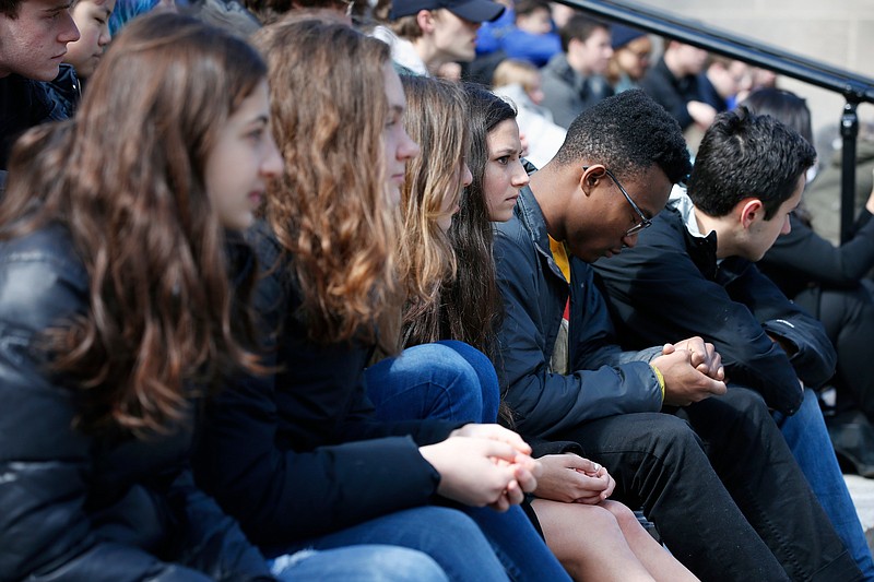 Harvard University students observe a moment of silence during a protest against school shootings and gun violence in Cambridge, Mass., last month.