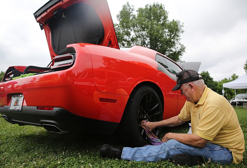 Myron Roach of Ringgold, Ga., shines the wheels of his 2018 Dodge Challenger Trans Am during the Harrison Ruritan Clubճ Car, Truck and Motorcycle Show Sunday, May 27, 2018 along the Tennessee Riverwalk in Chattanooga, Tenn. Typically, over 100 vehicles are entered in the car show, but lighter numbers were in attendance due to the threat of rain.