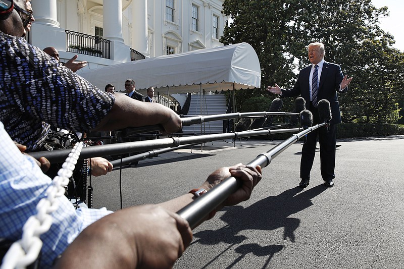 President Donald Trump speaks to the media as he walks to the Marine One helicopter Friday, May 25, 2018, on the South Lawn of the White House in Washington.