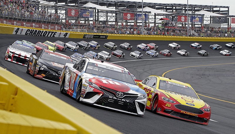 Kyle Busch, front left, leads the field at the start of the NASCAR Cup Series auto race at Charlotte Motor Speedway in Charlotte, N.C., Sunday, May 27, 2018. (AP Photo/Chuck Burton)