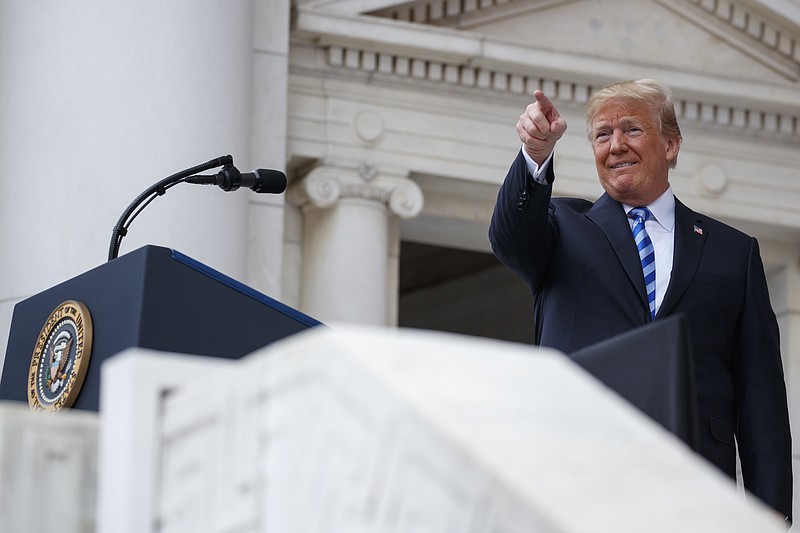 President Donald Trump points to the audience as he arrives for a Memorial Day ceremony at Arlington National Cemetery, Monday, May 28, 2018, in Arlington, Va. (AP Photo/Evan Vucci)