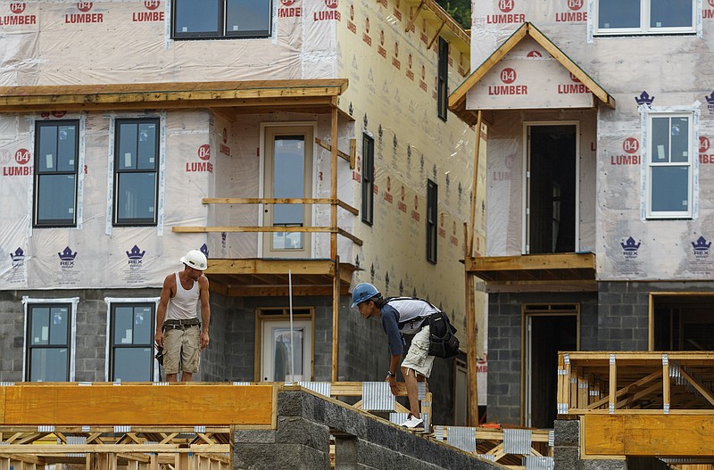 Workers construct townhomes in the Cameron Harbor development on Riverfront Parkway in downtown Chattanooga.