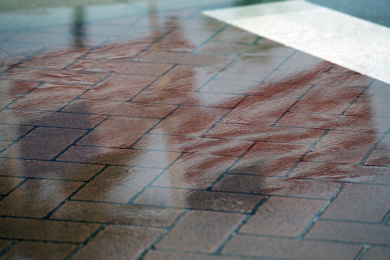 American flags placed in honor of Memorial Day are reflected in puddles at the Panama City Marina as Subtropical Storm Alberto approaches Panama City, Fla., Monday, May 28, 2018. (Joshua Boucher/News Herald via AP)