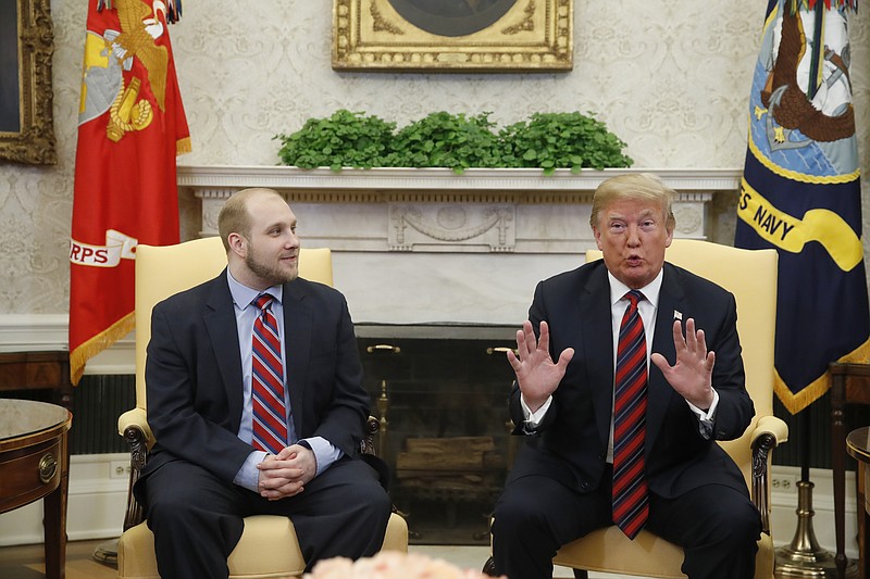 President Donald Trump, right, talks as Joshua Holt, who was recently released from a prison in Venezuela, joins him in the Oval Office of the White House, Saturday, May 26, 2018, in Washington. (AP Photo/Alex Brandon)