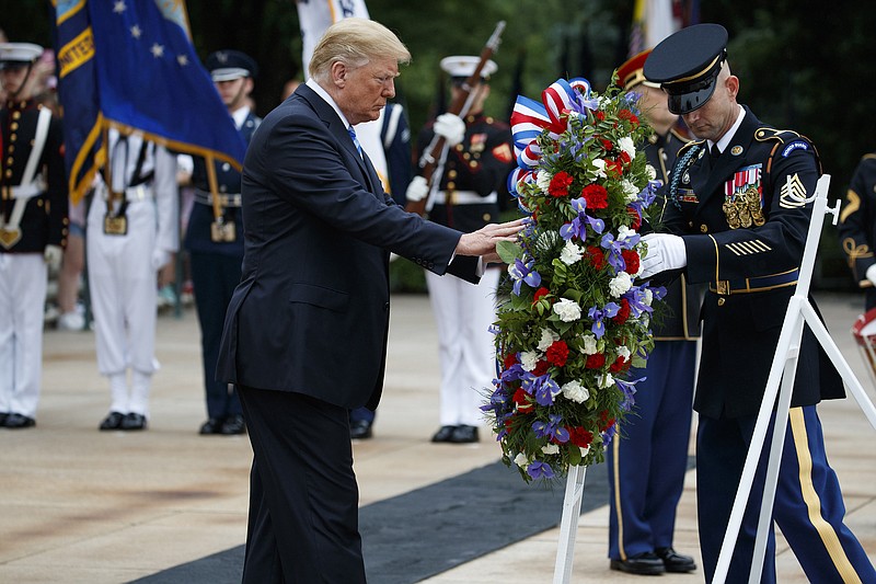 President Donald Trump lays a wreath during a Memorial Day ceremony at Arlington National Cemetery, Monday, May 28, 2018, in Arlington, Va. (AP Photo/Evan Vucci)