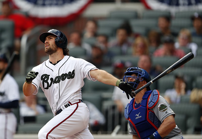 Atlanta Braves pinch hitter Charlie Culberson, left, follows through on a walkoff two-run home run in the ninth inning of the first game of a baseball doubleheader against the New York Mets, Monday, May 28, 2018, in Atlanta. (AP Photo/John Bazemore)