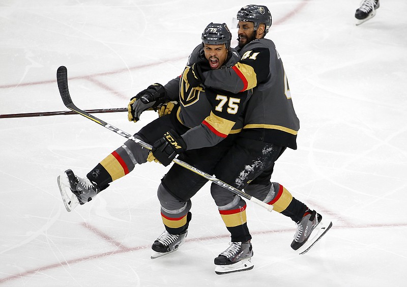 Vegas Golden Knights right wing Ryan Reaves, left, celebrates his goal with left wing Pierre-Edouard Bellemare, of France, during the third period in Game 1 of the NHL hockey Stanley Cup Finals against the Washington Capitals Monday, May 28, 2018, in Las Vegas. (AP Photo/Ross D. Franklin)