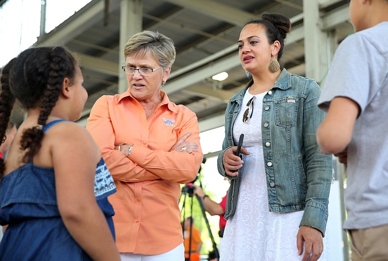 University of Tennessee women's basketball coach Holly Warlick, second from left, speaks with Teagan McClure, 7, Kristina McClure and Vincent McClure, 12, during the Big Orange Caravan Thursday, May 10, 2018, at the Tennessee Pavilion in Chattanooga, Tenn. A few hundred Vols fans made their way to the Tennessee Pavilion to get autographs from coaches and hear them speak.