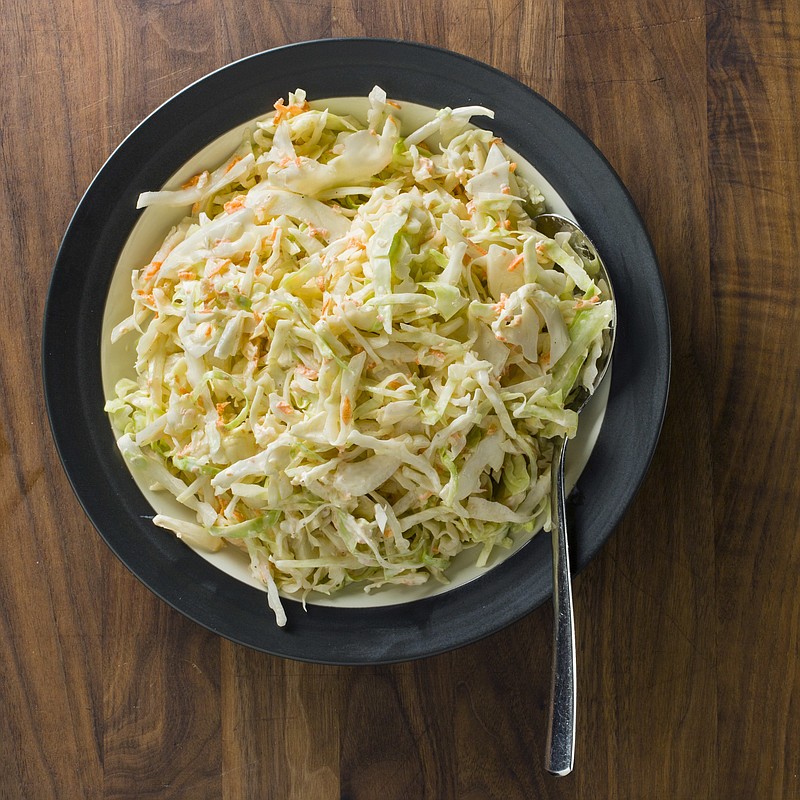 Ceamy buttermilk coleslaw appears in the cookbook "Complete Make-Ahead." (Steve Klise/America's Test Kitchen via AP)