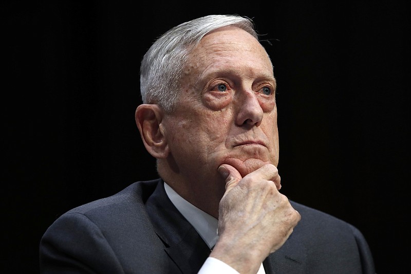 FILE - In this April 26, 2018, file photo, Defense Secretary Jim Mattis listens to a question during a hearing on Capitol Hill in Washington. Mattis says the U.S. will continue to confront China’s militarization of manmade islands in the South China Sea, arguing that Beijing hasn’t abided by its promise not to put weapons on the Spratly Islands. (AP Photo/Jacquelyn Martin, File)