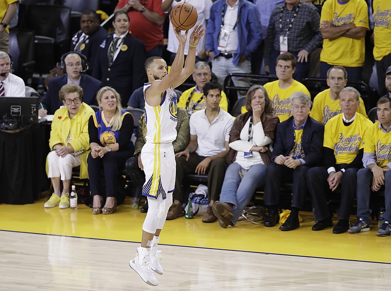 Golden State Warriors guard Stephen Curry shoots a 3-point basket against the Cleveland Cavaliers during the first half of Game 1 of basketball's NBA Finals in Oakland, Calif., Thursday, May 31, 2018. (AP Photo/Marcio Jose Sanchez)
