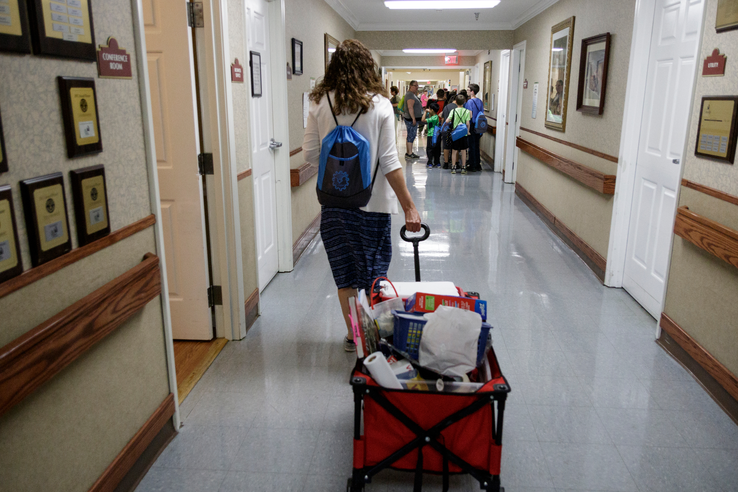 Teacher Beth Wilson wheels a cart of teaching supplies into Life Care Center of Red Bank on Tuesday, May 15, 2018, in Red Bank, Tenn. Wilson takes her class for active learning activities at the senior care facility.