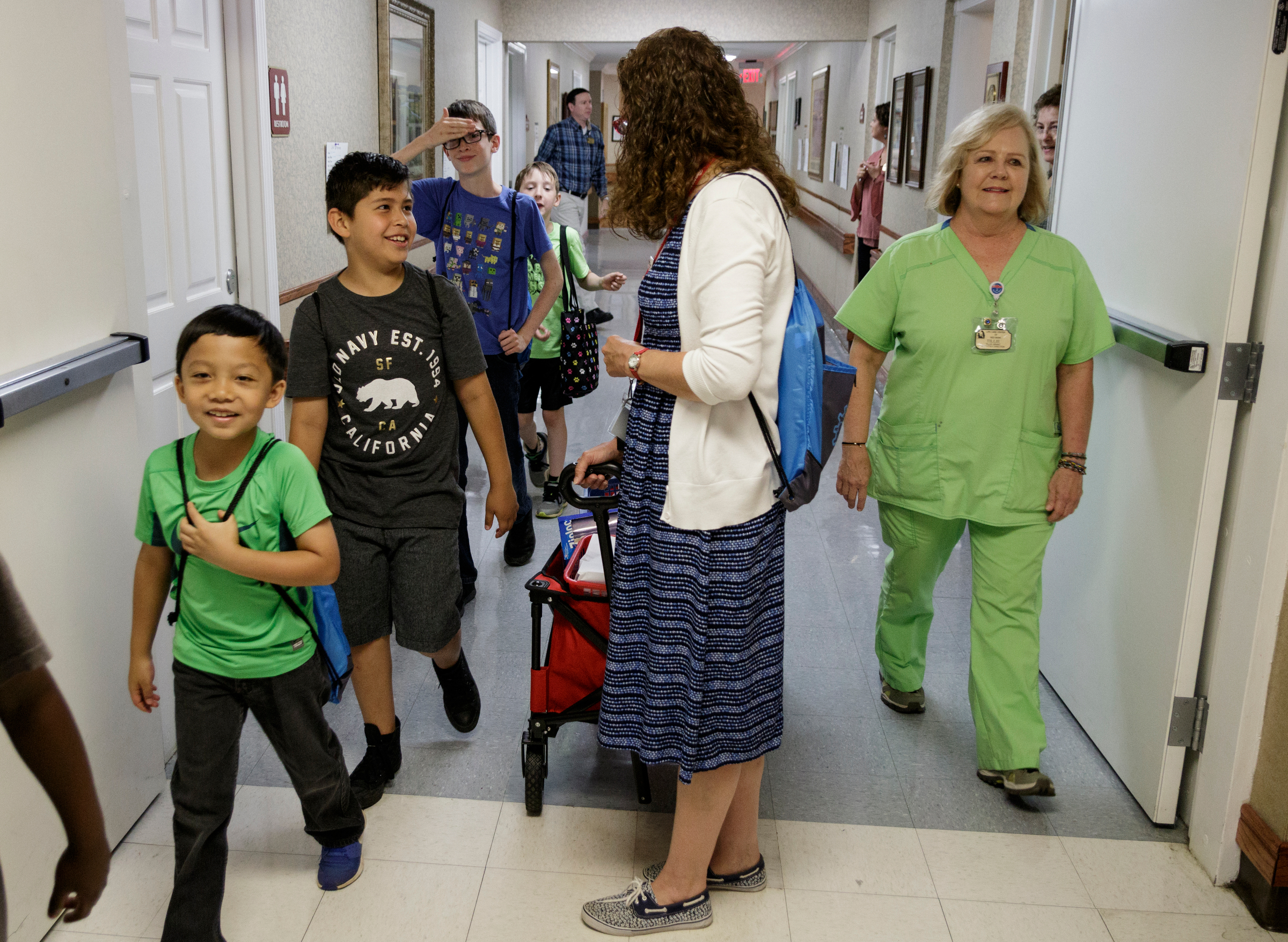 Teacher Beth Wilson, center, watches her class as they arrive at Life Care Center of Red Bank on Tuesday, May 15, 2018, in Red Bank, Tenn. Wilson takes her class for active learning activities at the senior care facility.