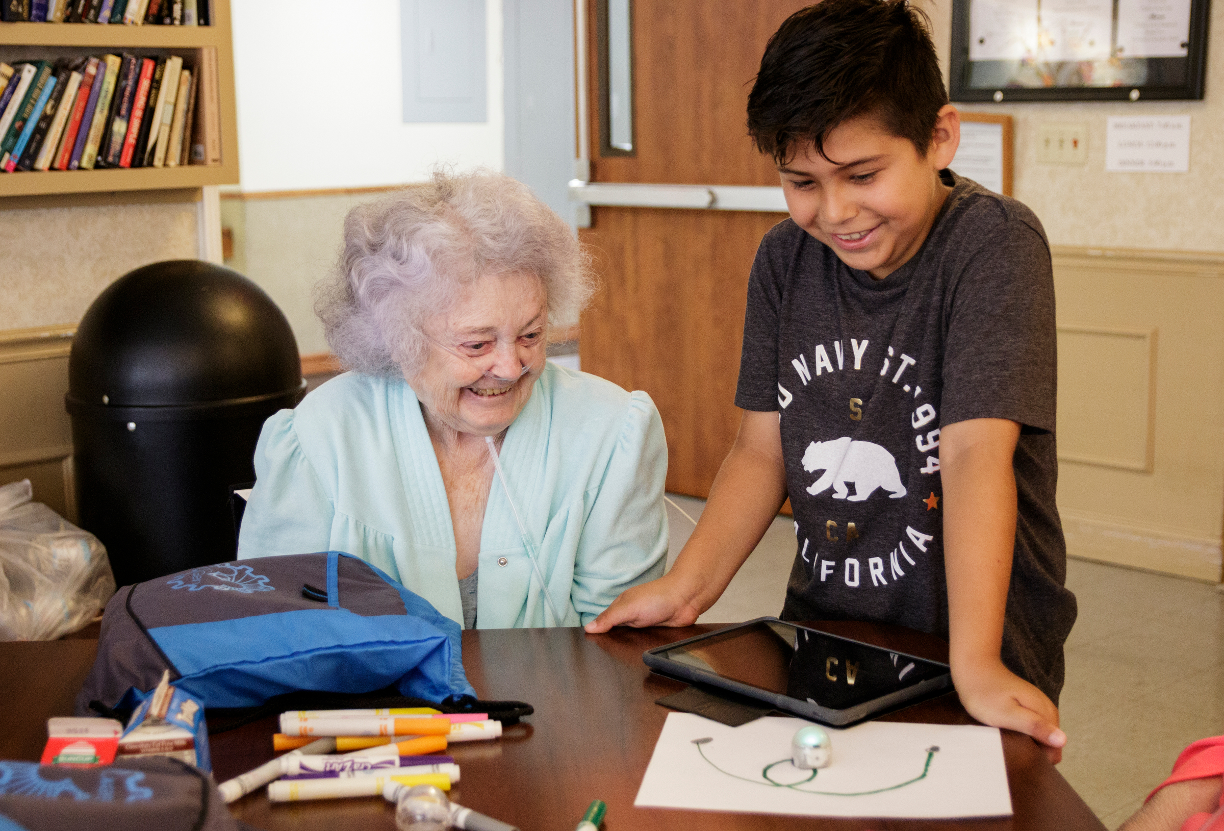 4th grader Joel Garcia, right, shows Delma Rea Stewart how an ozobot works at Life Care Center of Red Bank on Tuesday, May 15, 2018, in Red Bank, Tenn. Teacher Beth Wilson takes her class for active learning activities at the senior care facility.