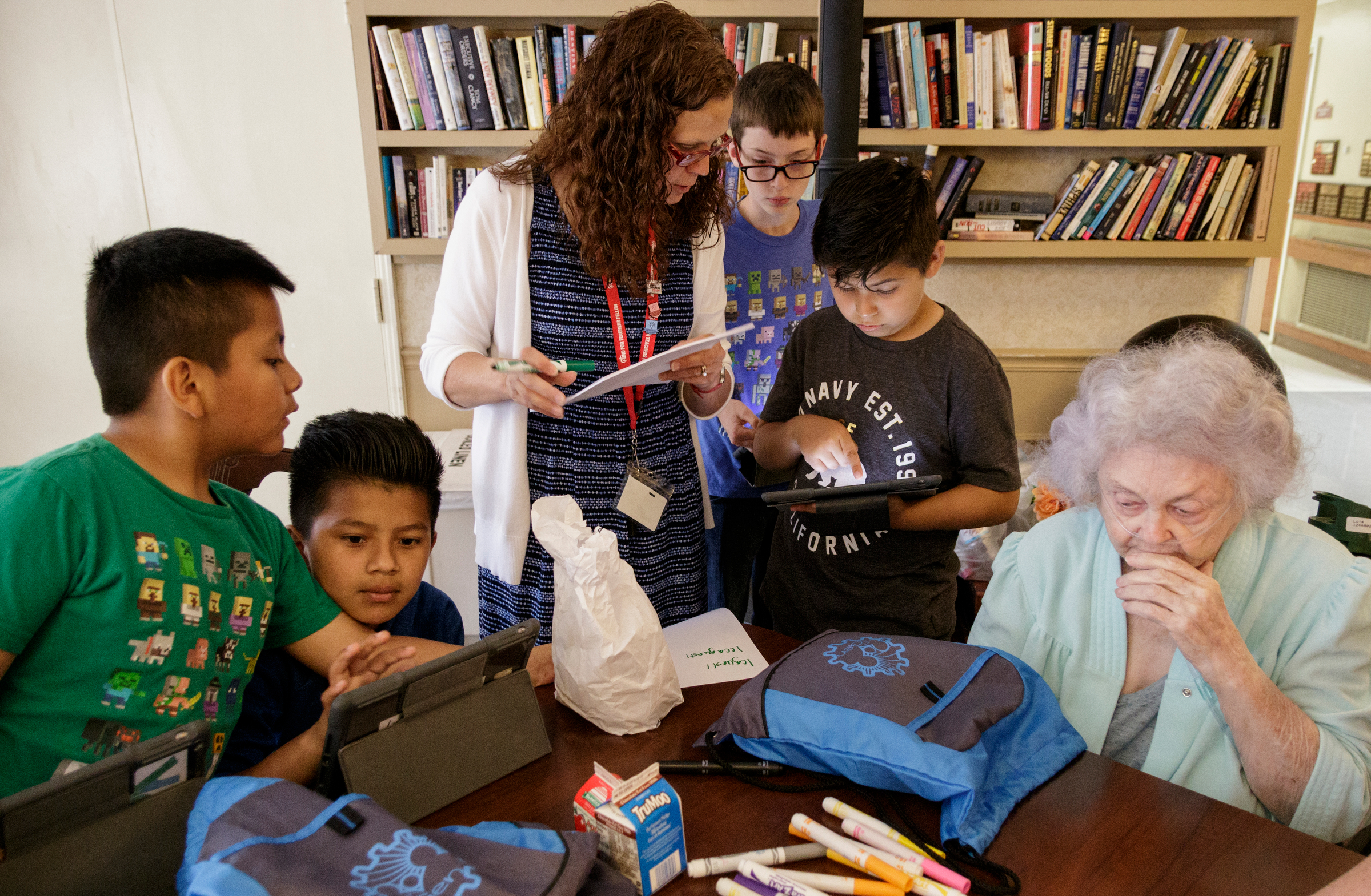 Teacher Beth Wilson, center, works with 4th grade students as they show Delma Rea Stewart, right, their schoolwork at Life Care Center of Red Bank on Tuesday, May 15, 2018, in Red Bank, Tenn. Wilson takes her class for active learning activities at the senior care facility.