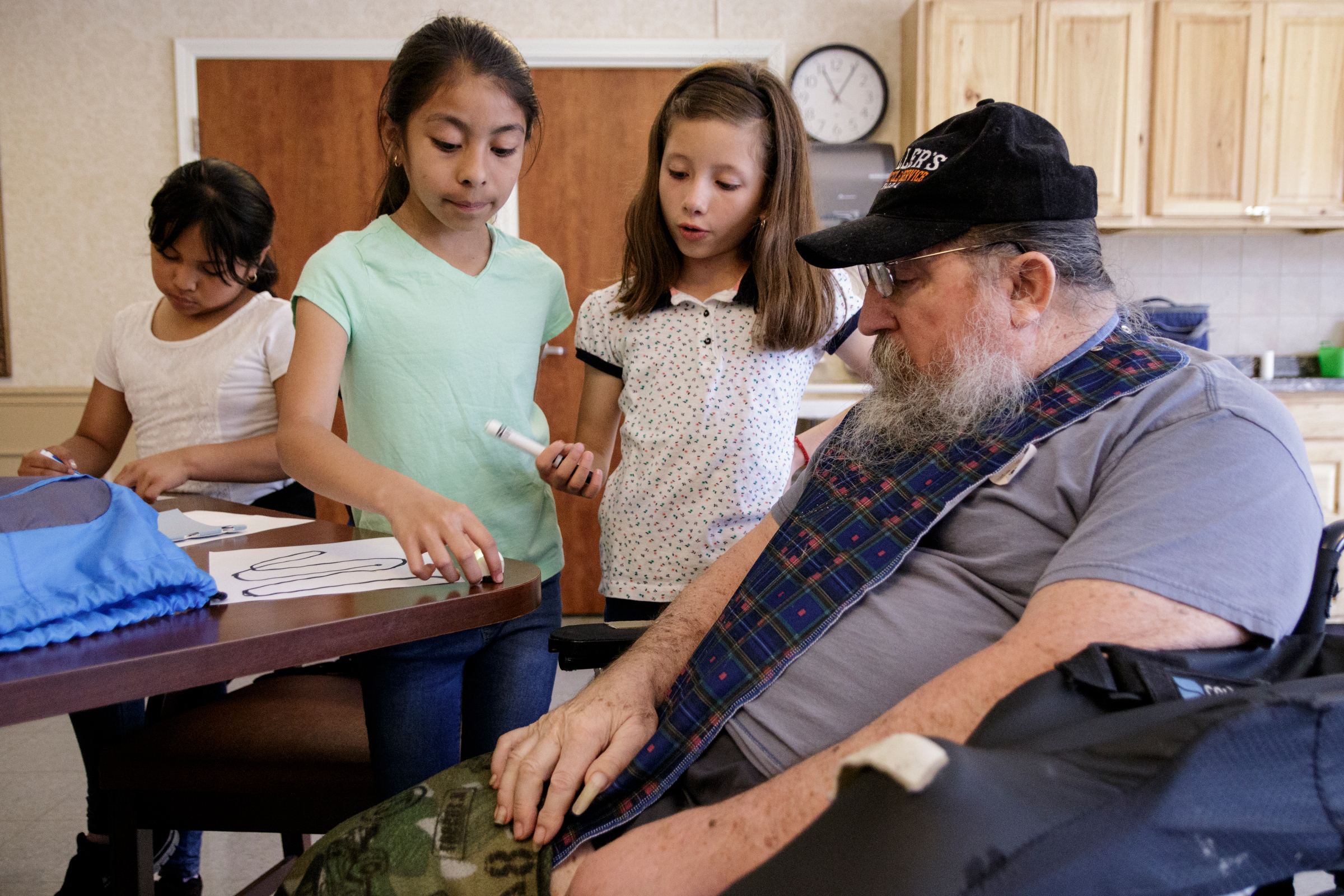 4th graders Carlita Maldonado, Emily Gutierrez, and Regina Linares, from left, show Joe Keller how an ozobot works at Life Care Center of Red Bank on Tuesday, May 15, 2018, in Red Bank, Tenn. Teacher Beth Wilson takes her class for active learning activities at the senior care facility.