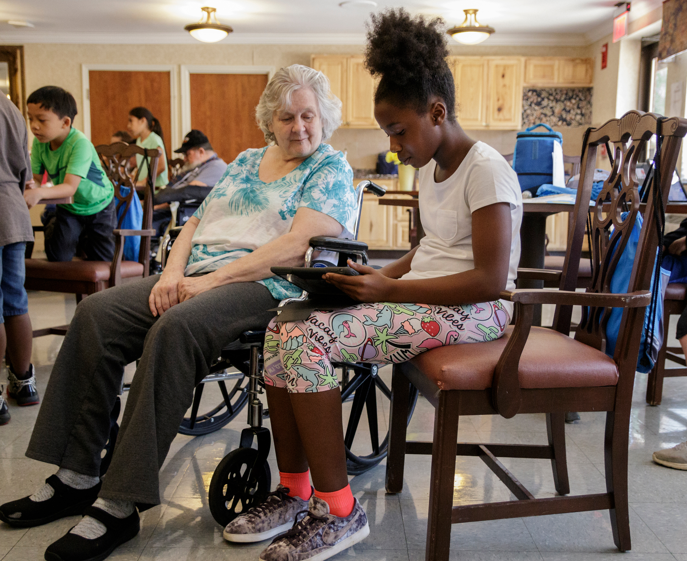 4th grader Amena Bennett, right, shows Elsie Ewton some of her schoolwork at Life Care Center of Red Bank on Tuesday, May 15, 2018, in Red Bank, Tenn. Teacher Beth Wilson takes her class for active learning activities at the senior care facility.