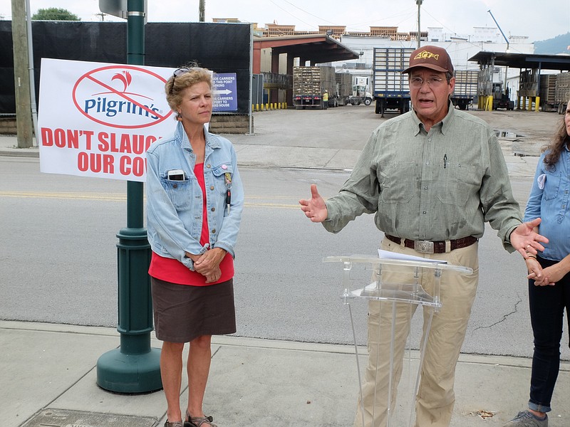 Downtown on Main Street, Blackwell Smith, right, longtime resident and business owner in Walker County, speaks about not wanting a Pilgrims Pride chicken plant in McLemore Cove Thursday outside the 1591 Broad Street plant in Chattanooga. Lizzie Caldwell, left, stands with the protest of the plant. Smith represents the McLemore Cove Preservation Society.