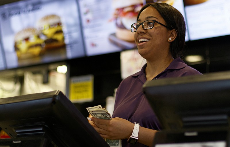 Vinceia Crittenden gets change for a customer at the McDonald's on Gunbarrel Road on Tuesday, May 29, 2018 in Chattanooga, Tenn. Crittenden, 20, has worked at the McDonald's since she was 15 years old.