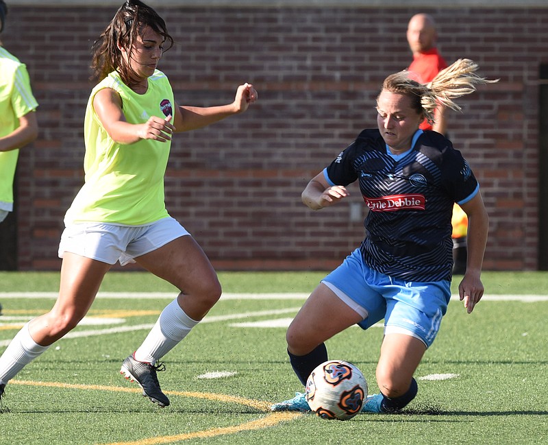 Chattanooga FC's Carlie Banks, right, regains control of the ball from the Nashville Rhythm's Carly Paschall in the first half of Sunday night's game at Finley Stadium. Banks scored in the 38th minute to send the match to halftime tied 1-1, and CFC went on to win 2-1.