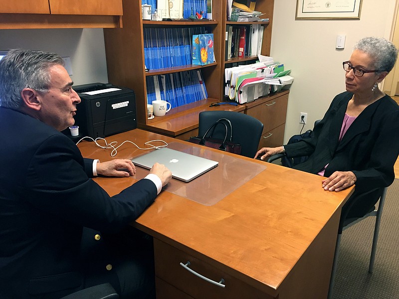 In this Thursday, May 24, 2018 photo, Adine Usher, 78, meets with breast cancer study leader Dr. Joseph Sparano at the Montefiore and Albert Einstein College of Medicine in the Bronx borough of New York. Usher was one of about 10,000 participants in the study which shows women at low or intermediate risk for breast cancer recurrence may safely skip chemotherapy without hurting their chances of survival. (AP Photo/Kathy Young)