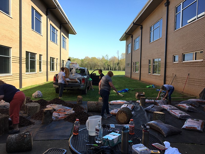 Students, teachers and parent volunteers help build the outdoor classroom at Hixson Middle School. (Contributed photo)