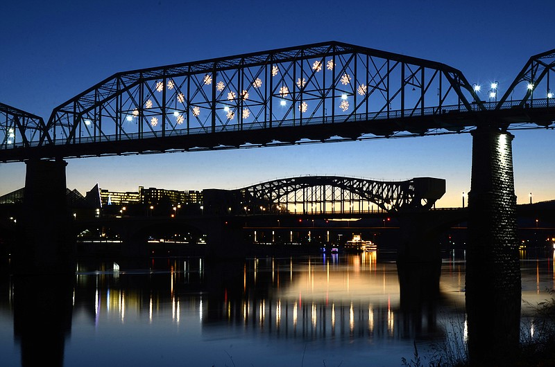 Snowflakes light up on the Walnut Street Bridge in this 2014 staff file photo.