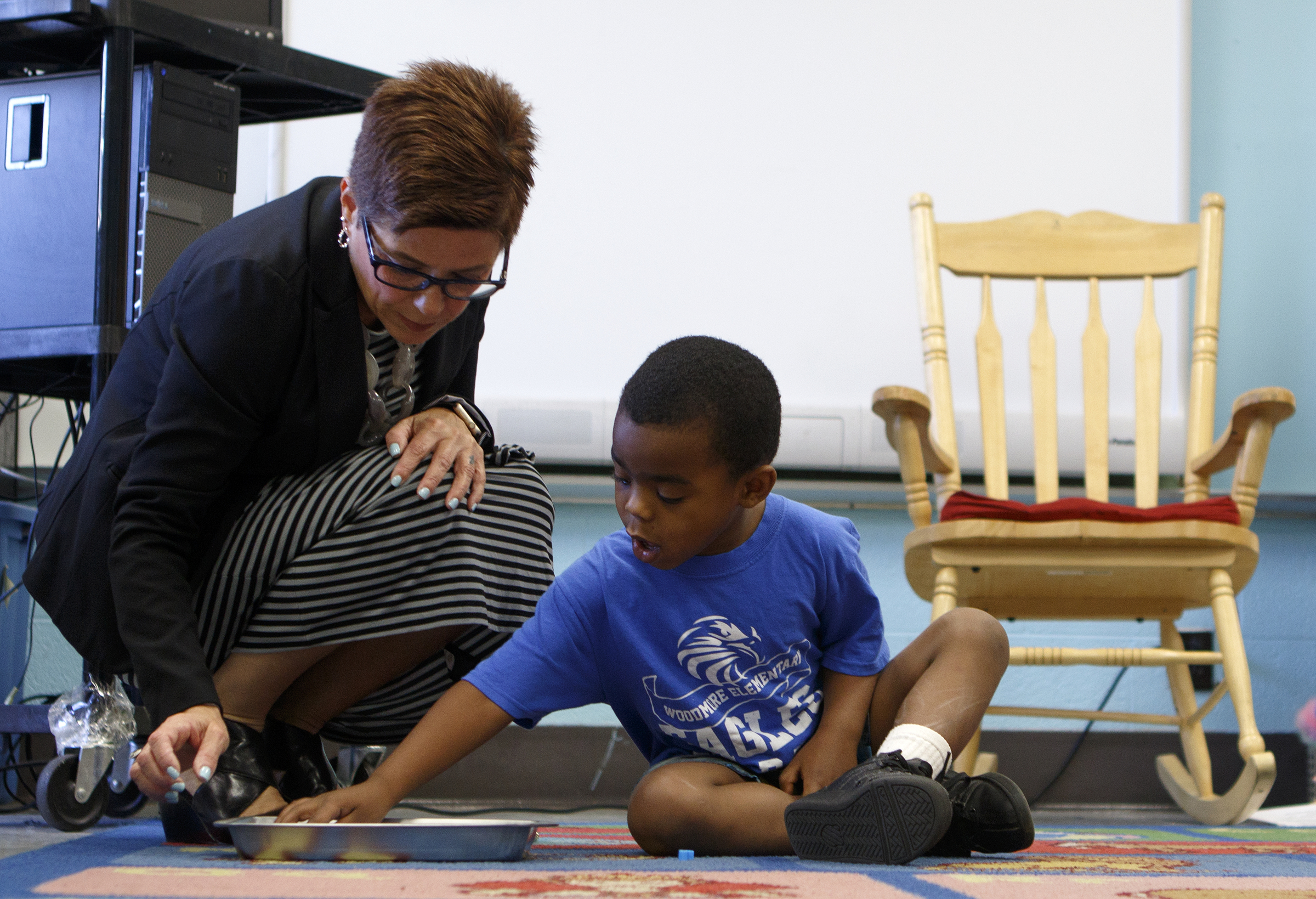 Chattanooga 2.0 Director of Programs Robin Cayce, left, helps Jonathan Lawrence spell his name with magnetic letters during Camp K at Woodmore Elementary School on Monday, June 4, 2018 in Chattanooga, Tenn.
