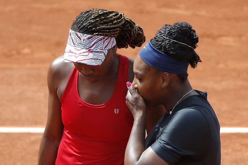 Serena Williams of the U.S., right, and her sister Venus Williams plays Slovenia's Andreja Klepac and Spain's Maria Jose Martinez Sanchez during their double match of the French Open tennis tournament at the Roland Garros stadium, Sunday, June 3, 2018 in Paris. (AP Photo/Michel Euler)

