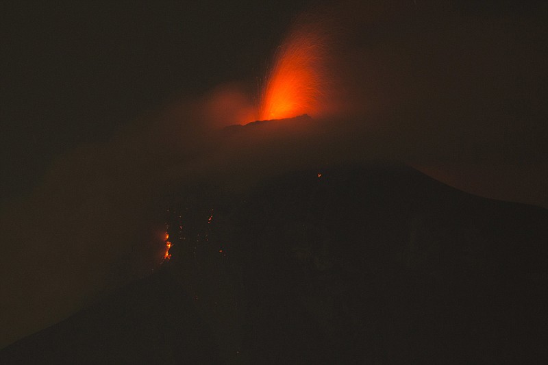 In this image taken with a long exposure, the Volcan de Fuego, or Volcano of Fire, spews molten rock from its crater in Alotenango, Guatemala, Sunday, June 3, 2018. Rescuers struggled to reach rural residents cut off by the deadly volcanic eruption Sunday. (AP Photo/Luis Soto)