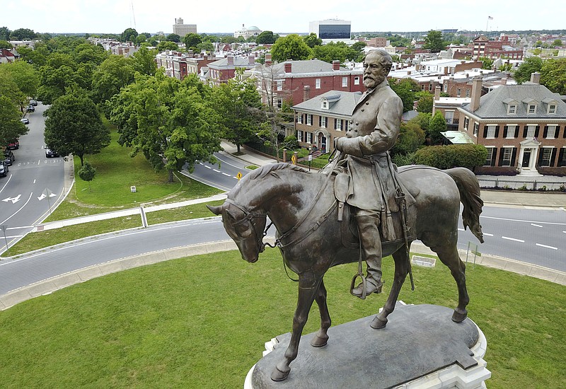 FILE - This June 27, 2017, file photo shows the statue of Confederate Gen. Robert E. Lee that stands in the middle of a traffic circle on Monument Avenue in Richmond, Va. A study released Monday, June 4, 2018, by the Southern Poverty Law Center shows about 110 Confederate monuments have been removed nationwide since 2015, when a racist shooting at a black church in South Carolina energized a movement against such memorials. (AP Photo/Steve Helber, File)