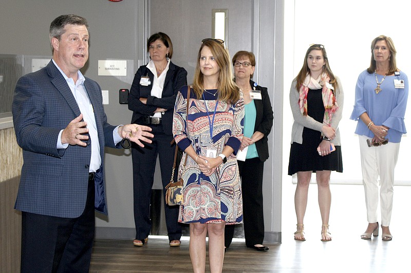 Dr. Jeffrey Woods, left, division president for Acadia Healthcare, leads a tour through the new Erlanger Behavioral Health Hospital on Tuesday, June 5, 2018. 