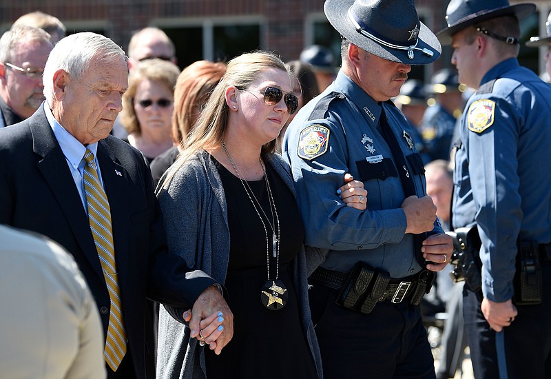 Lisa Baker, widow of Dickson County Sheriff's Sgt. Daniel Baker Tuesday, leaves his funeral June 5, 2018, at First Baptist Church in Dickson, Tenn.