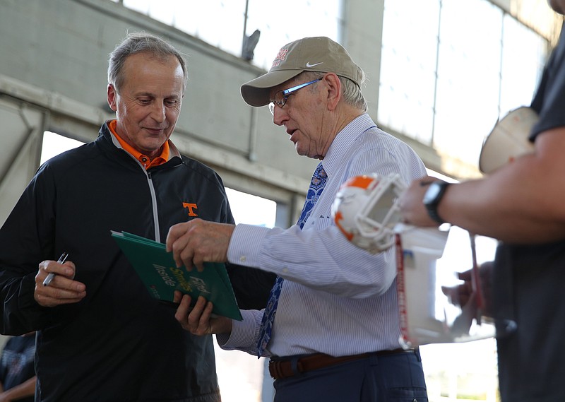 University of Tennessee basketball coach Rick Barnes signs an autograph for Russell Bean during the Big Orange Caravan Thursday, May 10, 2018, at the Tennessee Pavilion in Chattanooga, Tenn.