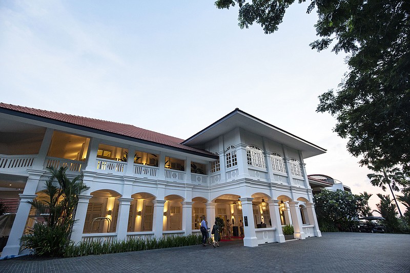 An entrance glows outside the Capella Hotel on Sentosa Island in Singapore Tuesday, June 5, 2018. U.S. President Donald Trump and North Korean leader Kim Jong Un will meet at the luxury resort for nuclear talks next week in Singapore, the White House said Tuesday. (AP Photo/Yong Teck Lim)