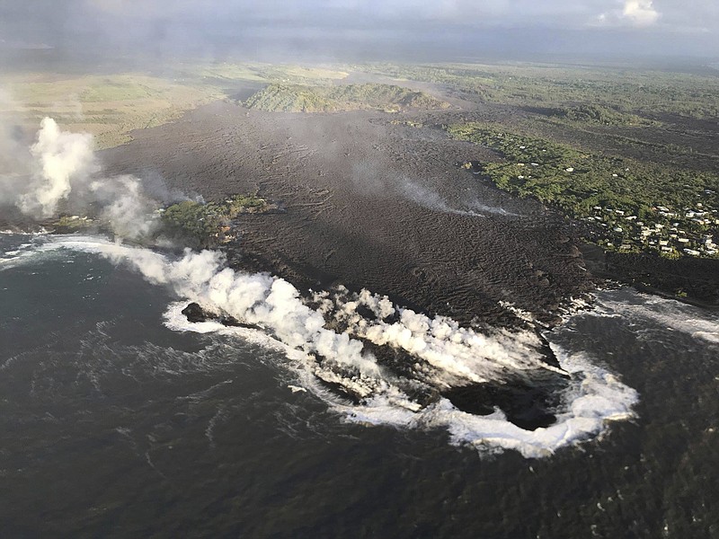 This photo provided by U.S. Geological Survey shows an aerial view of ocean entry at Kapoho Bay, Hawaii on Tuesday, June 5, 2018. Lava destroyed hundreds of homes in mostly rural Hawaii area overnight, a county spokeswoman said Tuesday. A morning overflight confirmed that lava completely filled Kapoho Bay, inundated most of Vacationland and covered all but the northern part of Kapoho Beach Lots, scientists with the U.S. Geological Survey's Hawaiian Volcano Observatory said. (U.S. Geological Survey via AP)