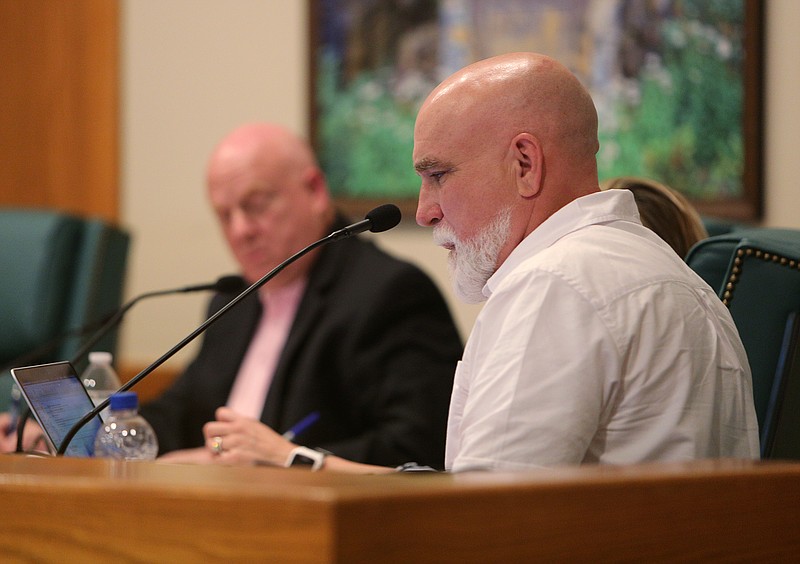 Signal Mountain Councilman Dan Landrum reads from a previously adopted document at Signal Mountain Town Hall Wednesday, June 6, 2018 in Signal Mountain, Tennessee. The council voted against rezoning an area to accommodate a big-box grocery store to inhabit the area. 