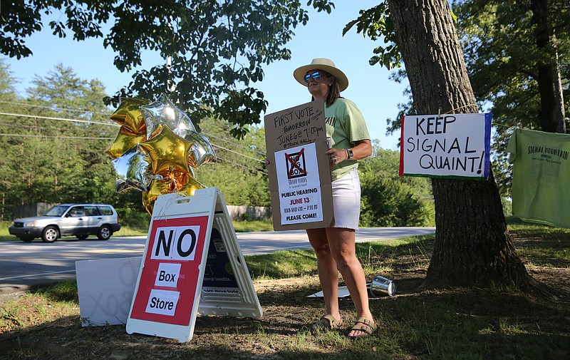 Susannah Murdock, a member of the steering committee for the Signal Voters for Sustainable Growth, stands out by the road at Signal Mountain Town Hall as cars enter and pass Wednesday, June 6, 2018 in Signal Mountain, Tennessee. Murdock was one of many Signal Mountain residents against rezoning an area to allow for a big-box grocery store. 