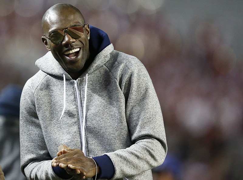 Former NFL wide receiver and Chattanooga alum Terrell Owens walks the sidelines during the second half of an NCAA college football game with Alabama and Chattanooga, Saturday, Nov. 19, 2016, in Tuscaloosa, Ala. (AP Photo/Brynn Anderson)