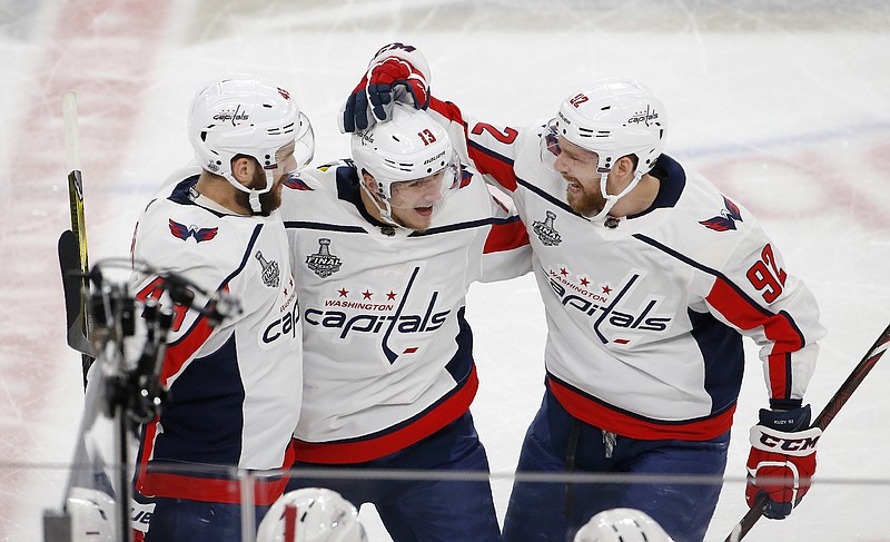 Washington Capitals left wing Jakub Vrana, center, celebrates his goal with right wing Tom Wilson, left, and center Evgeny Kuznetsov during the second period in Game 5 of the NHL hockey Stanley Cup Finals against the Vegas Golden Knights on Thursday, June 7, 2018, in Las Vegas. (AP Photo/Ross D. Franklin)