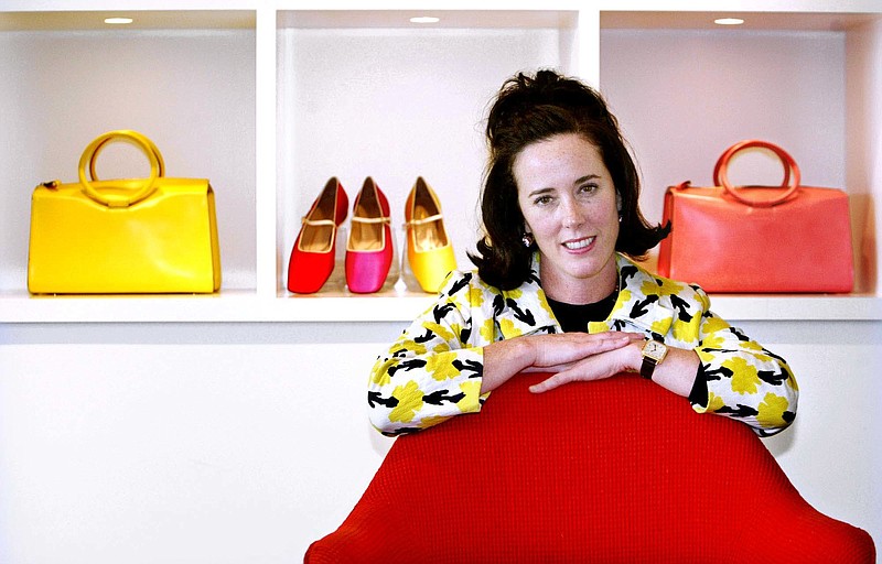 FILE - In this May 13, 2004 file photo, designer Kate Spade poses with handbags and shoes from her collection in New York. She was found dead in her apartment this week in an apparent suicide. (AP Photo/Bebeto Matthews, File)