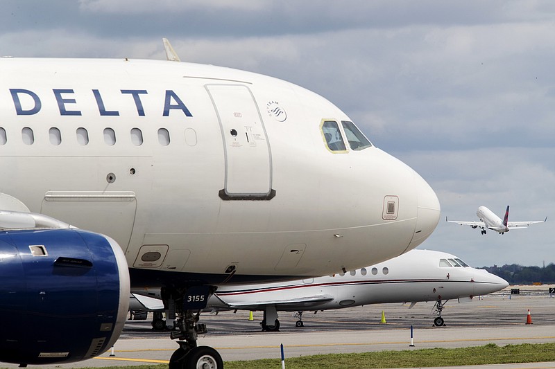 
              FILE - In this Aug. 8, 2017, file photo, a Delta Air Lines jet waits on the tarmac at LaGuardia Airport in New York. A false offer circulating on Facebook shows what appears to be a promotion from Delta claiming the company is giving away free tickets to celebrate its 93rd birthday. Delta says the promotion is a fake and the airline is not celebrating its 93rd birthday this year. (AP Photo/Mary Altaffer, File)
            
