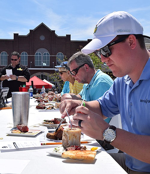 Judges dig into the entries submitted by teams participating in the inaugural Ooltewah BBQ Brawl held last year in Cambridge Square. This year's event is June 23.