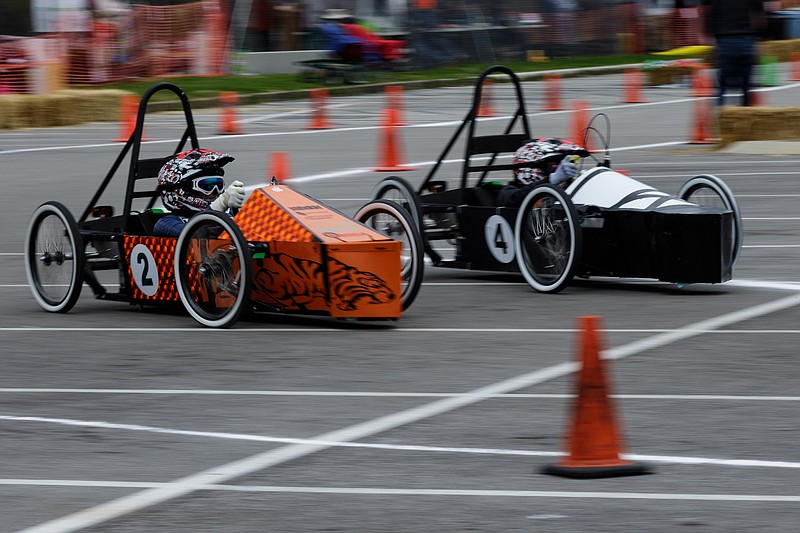 The Howard High car (2) overtakes a CSLA car during the 2018 Chattanooga Green Prix at Chattanooga State Technical Community College on Saturday, March 24, 2018, in Chattanooga, Tenn. Students from area schools built single-seat electric race cars to compete in the event.