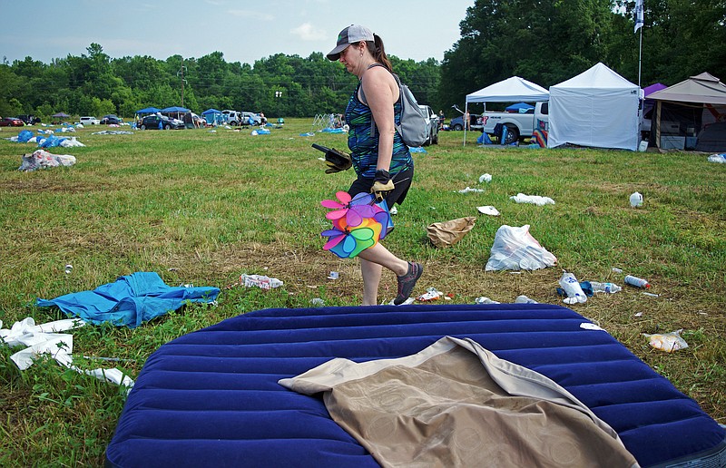 Mark Pace/Chattanooga Times Free Press —Leslie Smith carries belongings left at Bonnaroo following the music festival. A crew of volunteers helped collect used gear from the festival Monday to sell in the Gear Closet's annual sale taking place today from 10 a.m.-6 p.m.