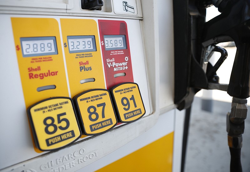 FILE- In this May 25, 2018, file photo prices for the three grades of gasoline light up the pump at a Shell station in southeast Denver. On Tuesday, June 12, the Labor Department reports on U.S. consumer prices for April. (AP Photo/David Zalubowski, File)