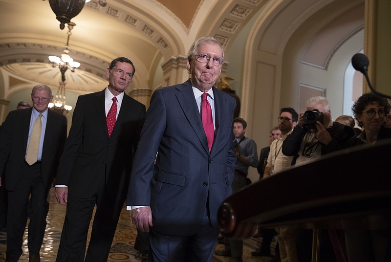 Senate Majority Leader Mitch McConnell, R-Ky., joined by Sen. James Inhofe, R-Okla., a member of the Senate Armed Services Committee, far left, and Sen. John Barrasso, R-Wyo., second from left, arrives for a news conference on Capitol Hill in Washington, Tuesday, June 12, 2018. Republican and Democratic leaders aren't quite celebrating President Donald Trump's historic meeting Tuesday with North Korea's Kim Jong Un, saying the initial agreement they struck won't mean much unless the North completely denuclearizes. (AP Photo/J. Scott Applewhite)